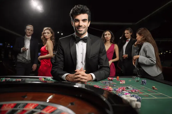 A glamorous woman holding casino chips in a neon-lit environment, representing the premium online casino atmosphere of KKBDT.