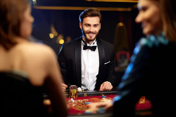 A glowing roulette wheel with cascading chips, symbolizing the engaging live and instant-win games available on KKBDT.